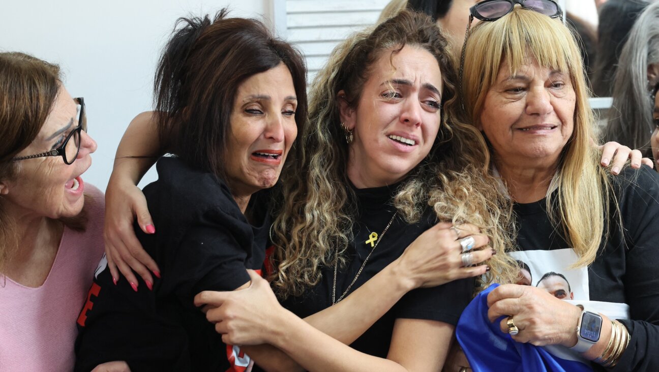 Close relatives of Israeli hostage Eli Sharabi, at the family home in Tel Aviv, react as they watch on a television screen his release along with two other hostages in the Gaza Strip, Feb. 8, 2025. (Jack Guez/AFP via Getty Images)