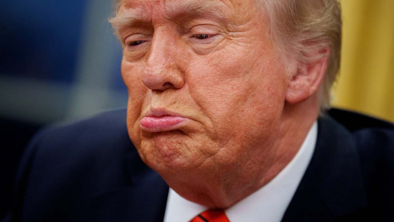 President Donald Trump  takes a question from a reporter after signing a series of executive orders.