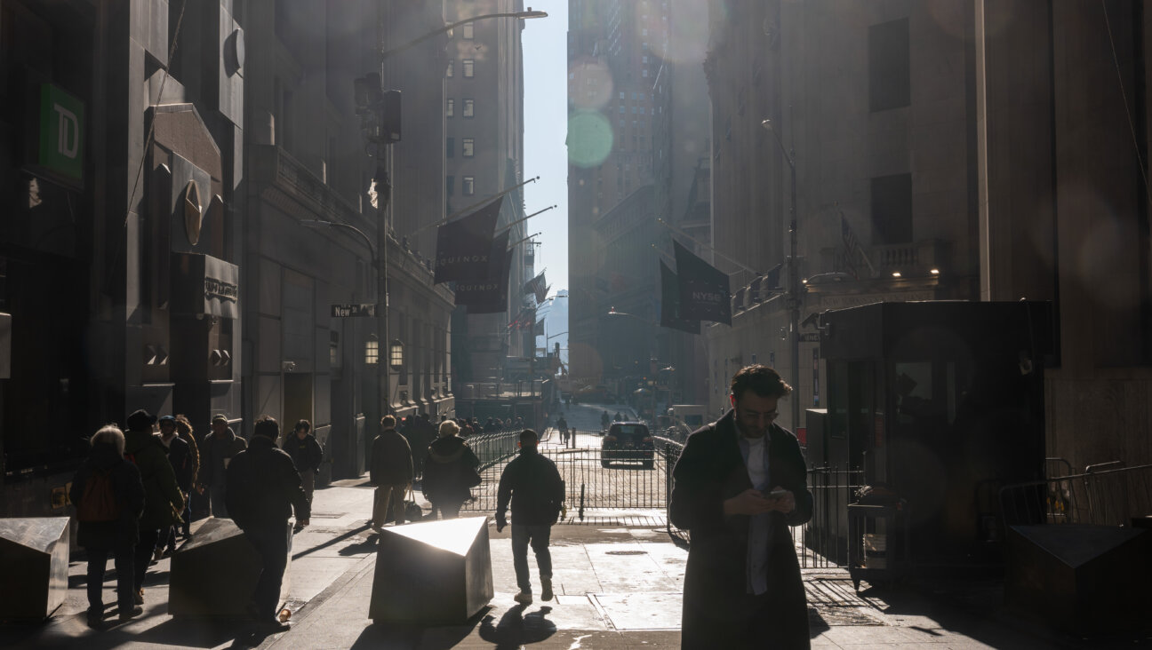 People walk by the New York Stock Exchange in Manhattan on on Monday.