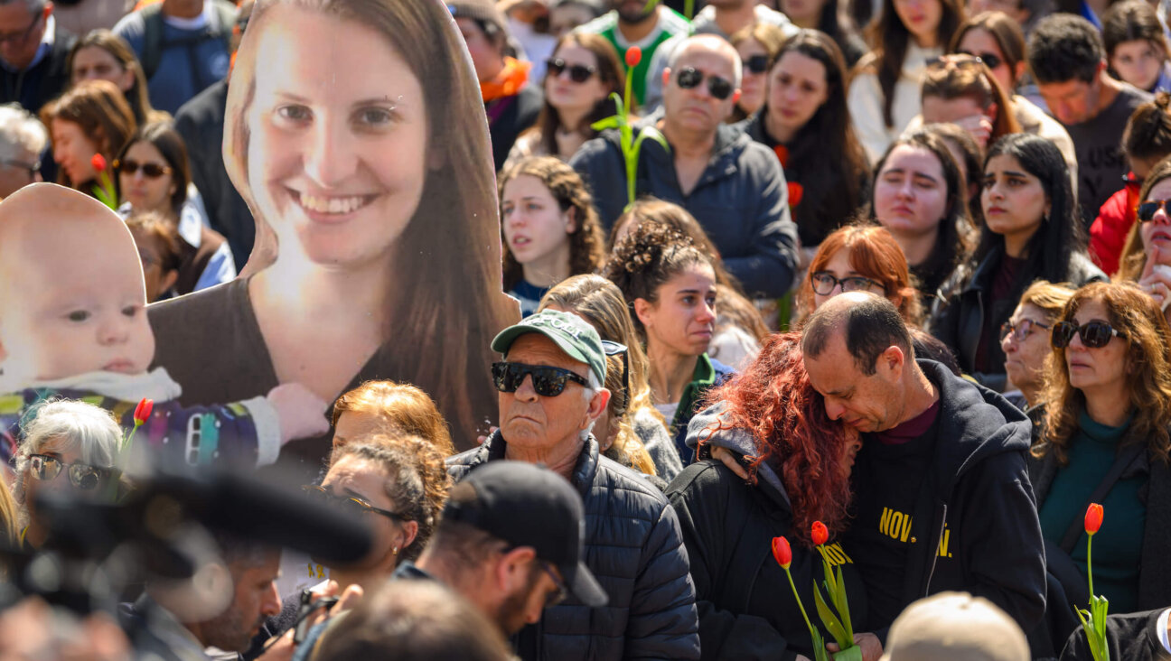 A crowd watches a live feed from a funeral for Shiri, Ariel and Kfir Bibas  in Hostages Square in Tel Aviv on Feb. 26. 