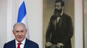 Israeli Prime Minister Benjamin Netanyahu is seen before a portrait of Theodor Herzl, known as the “Visionary of the Jewish State” and the founder of modern Zionism in Jerusalem on May 2, 2018. (Abir Sultan/Pool/AFP via Getty Images)