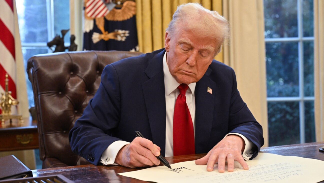 President Donald Trump signs an executive order in the Oval Office of the White House in Washington, DC, on Jan. 30, 2025. (Roberto Schmidt / AFP via Getty Images)