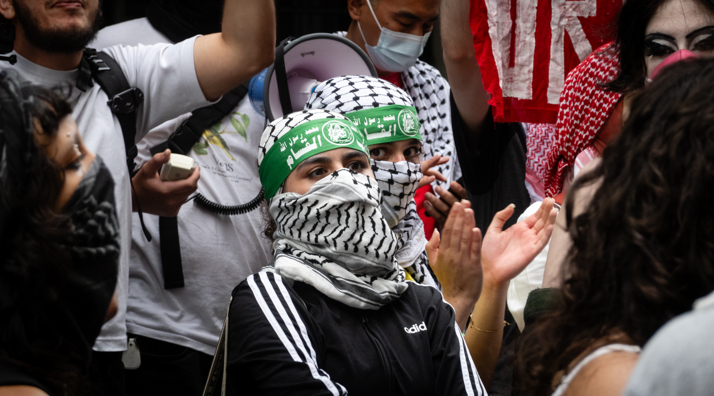 Anti-Israel protesters demonstrating outside Baruch College wore Hamas headbands and bearing flags and symbols of terror groups, June 5, 2024. (Luke Tress)