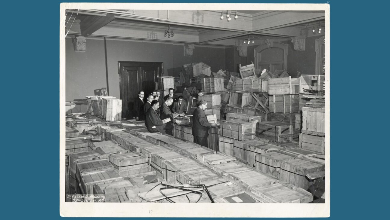 Leaders of the New York-based YIVO open crates of salvaged materials from Europe in 1947 at the Manischewitz matzah warehouse in New Jersey. (YIVO Institute of Jewish Research)