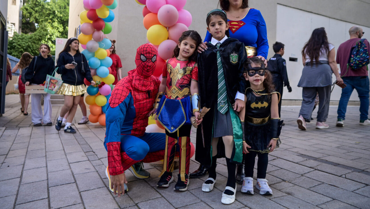 Children and their teachers and parents dressed up for Purim, some as Batman in honor of the slain Bibas brothers, at the Gabrieli Carmel School in Tel Aviv, March 13, 2025.(Avshalom Sassoni/Flash90)