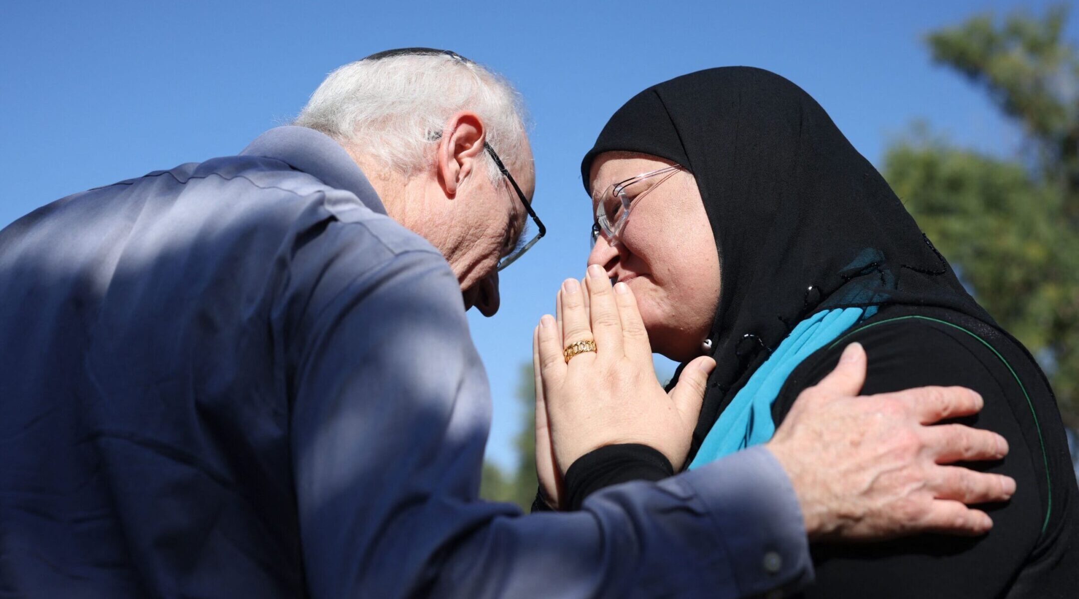 Nir Silver greets Arab-Israeli Ghadir Hani, a fellow peace activist from Acre, during a memorial service held Nov. 16, 2023 at Kibbutz Gezer in central Israel for his sister, Vivian Silver, who was killed in the Hamas attacks of Oct. 7. Vivian Silver was a co-founder of Women Wage Peace, a grantee of the U.S. peace-building fund known as MEPPA. (Oren Ziv/AFP via Getty Images)