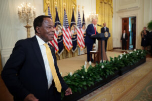 Civil rights attorney Leo Terrell leaves the stage after speaking alongside President Donald Trump and golf legend Tiger Woods during a reception honoring Black History Month at the White House on February 20.