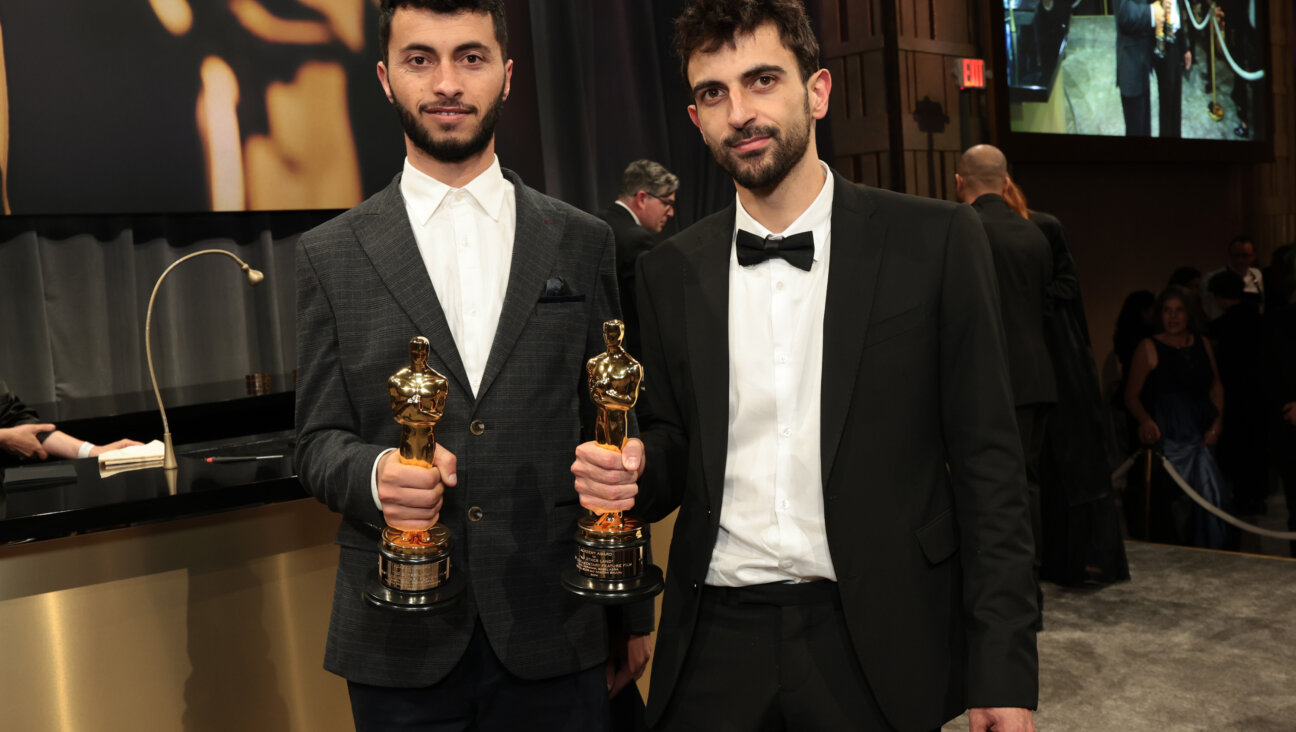 Basel Adra (L) and Yuval Abraham, winners of the Best Documentary Feature award for "No Other Land," holding their Oscars.