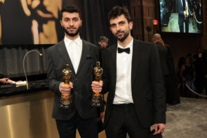 Basel Adra (L) and Yuval Abraham, winners of the Best Documentary Feature award for "No Other Land," holding their Oscars.