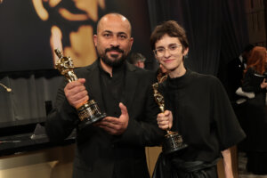 (L-R) Hamdan Ballal and Rachel Szor, winners of the Best Documentary Feature Film for "No Other Land", attend the 97th Annual Oscars Governors Ball.