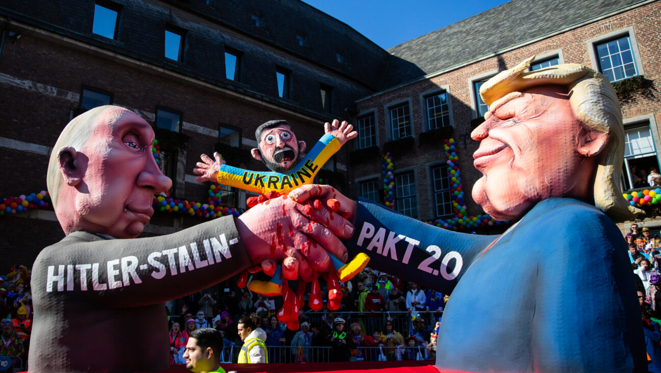 At a carnival parade in Dusseldorf, Germany, a float depicts Donald Trump and Vladimir Putin crushing Volodymyr Zelensky.