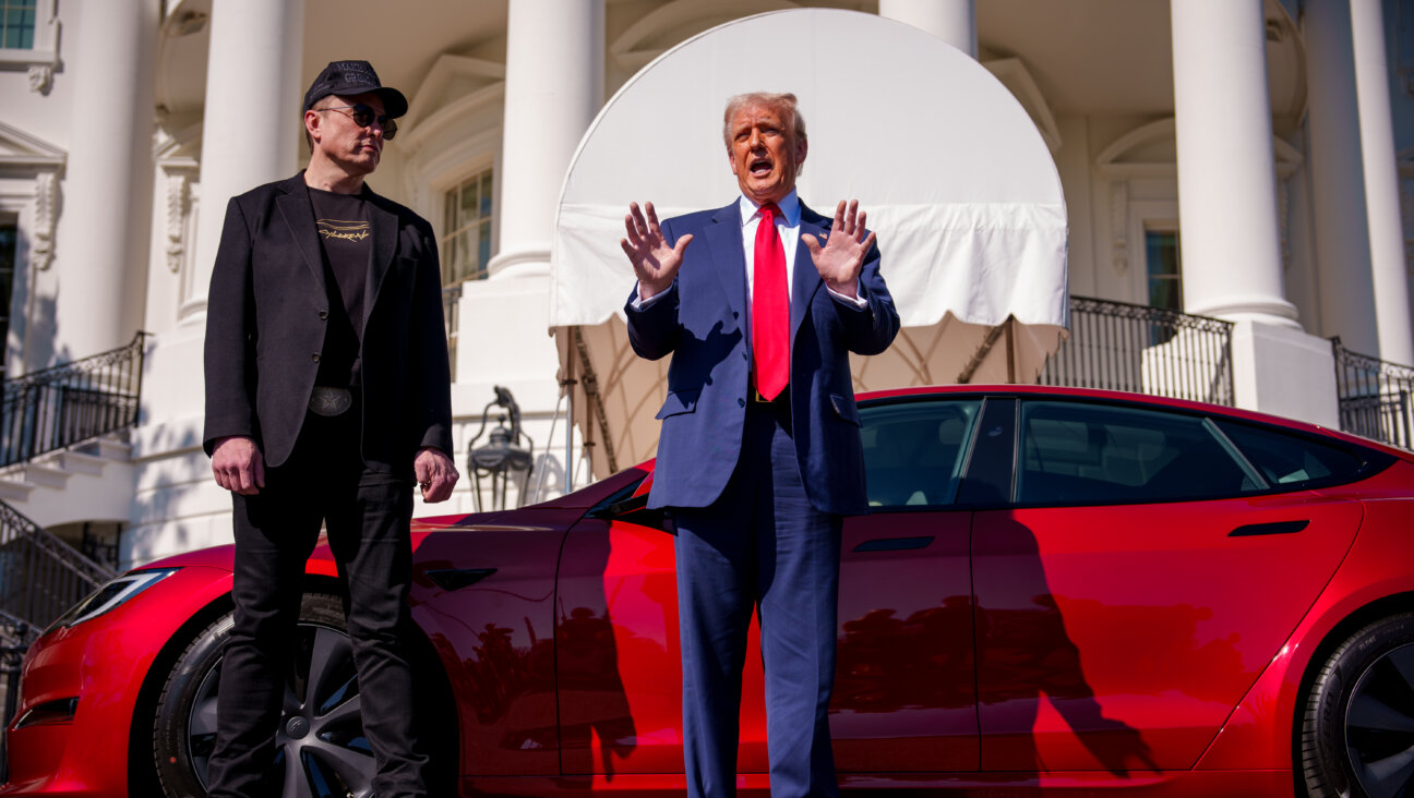 President Donald Trump, accompanied by adviser and Tesla CEO Elon Musk, promotes a Tesla Model S on the South Lawn of the White House on March 11.