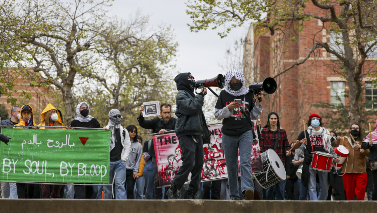 Pro-Palestinian protesters march at UCLA on Tuesday, opposing ICE's detainment of Mahmoud Khalil, a Palestinian activist who led protests at Columbia University last year.