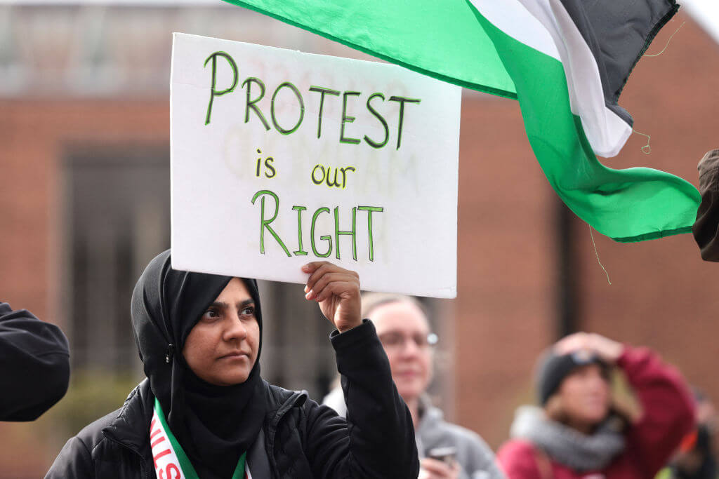 A woman holds a sign at a demonstration in support of Mahmoud Khalil at the University of Washington campus in Seattle on March 15, 2025.