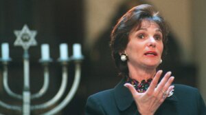 Kitty Dukakis, taking her father Harry Ellis Dickson’s place, speaks to a crowd gathered at the Vilna Shul on Beacon Hill in Boston on Oct. 28, 1995, as part of the Combined Jewish Philanthropies commemoration of 16 historic Jewish buildings in Boston. (Michael Robinson Chavez/The Boston Globe via Getty Images)