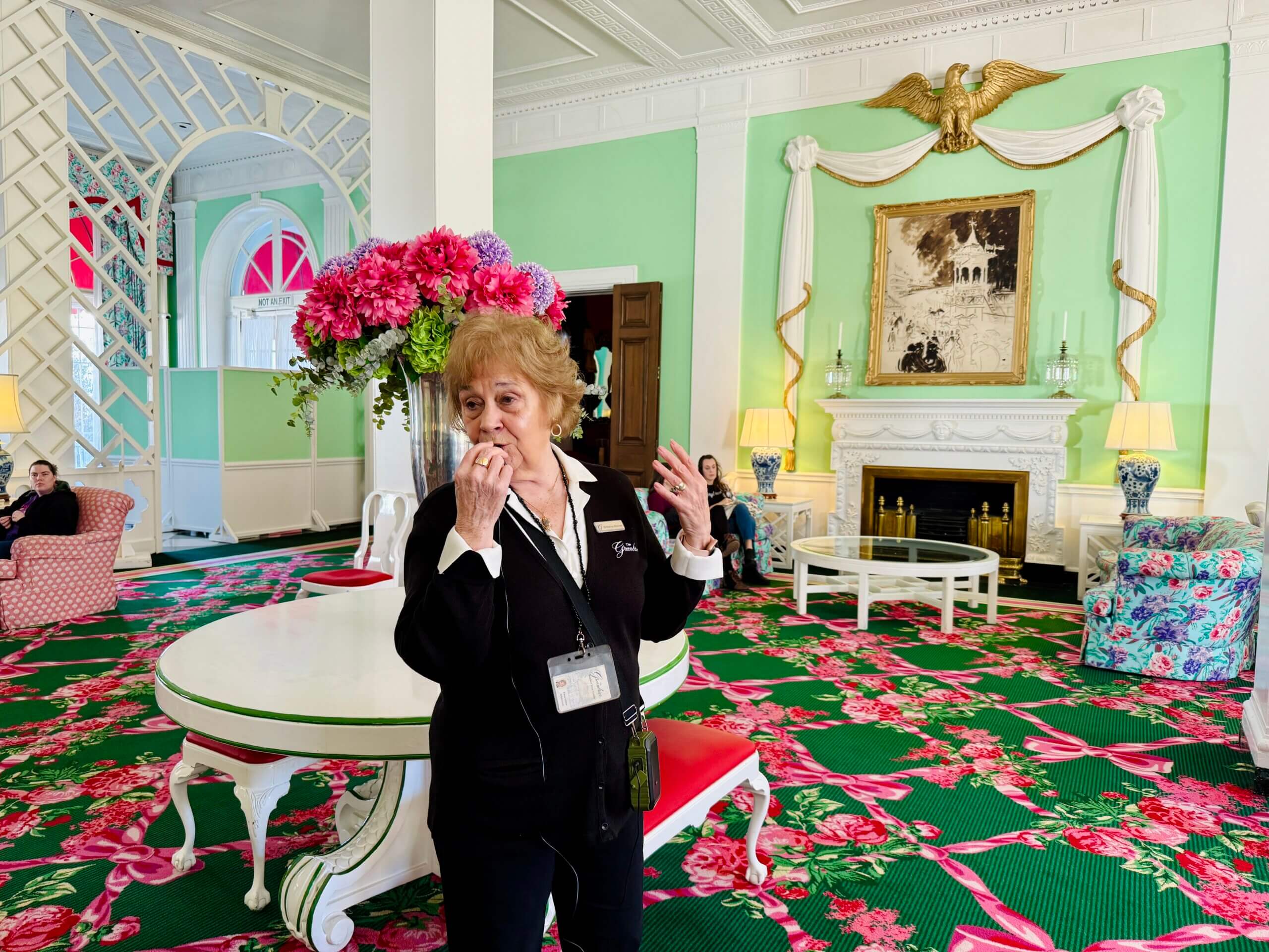 A guide speaking into a microphone leading a tour through the West Virginia's Greenbrier resort in March 2025.