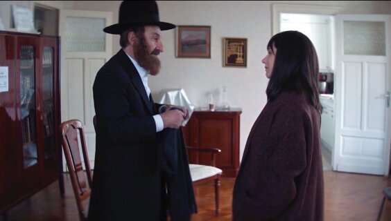 Nuchem Shtisel (played by Sasson Gabai) paying a shiva call to Penina Baumbach (Rotem Abuhab)