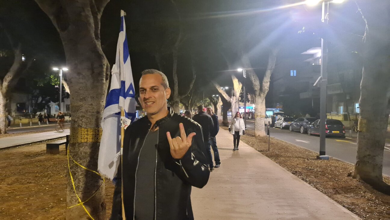 Yoni, who identifies as “more right-wing than Bibi,” joined a mass protest in Tel Aviv against the Israeli prime minister, March 22, 2025. (Deborah Danan)