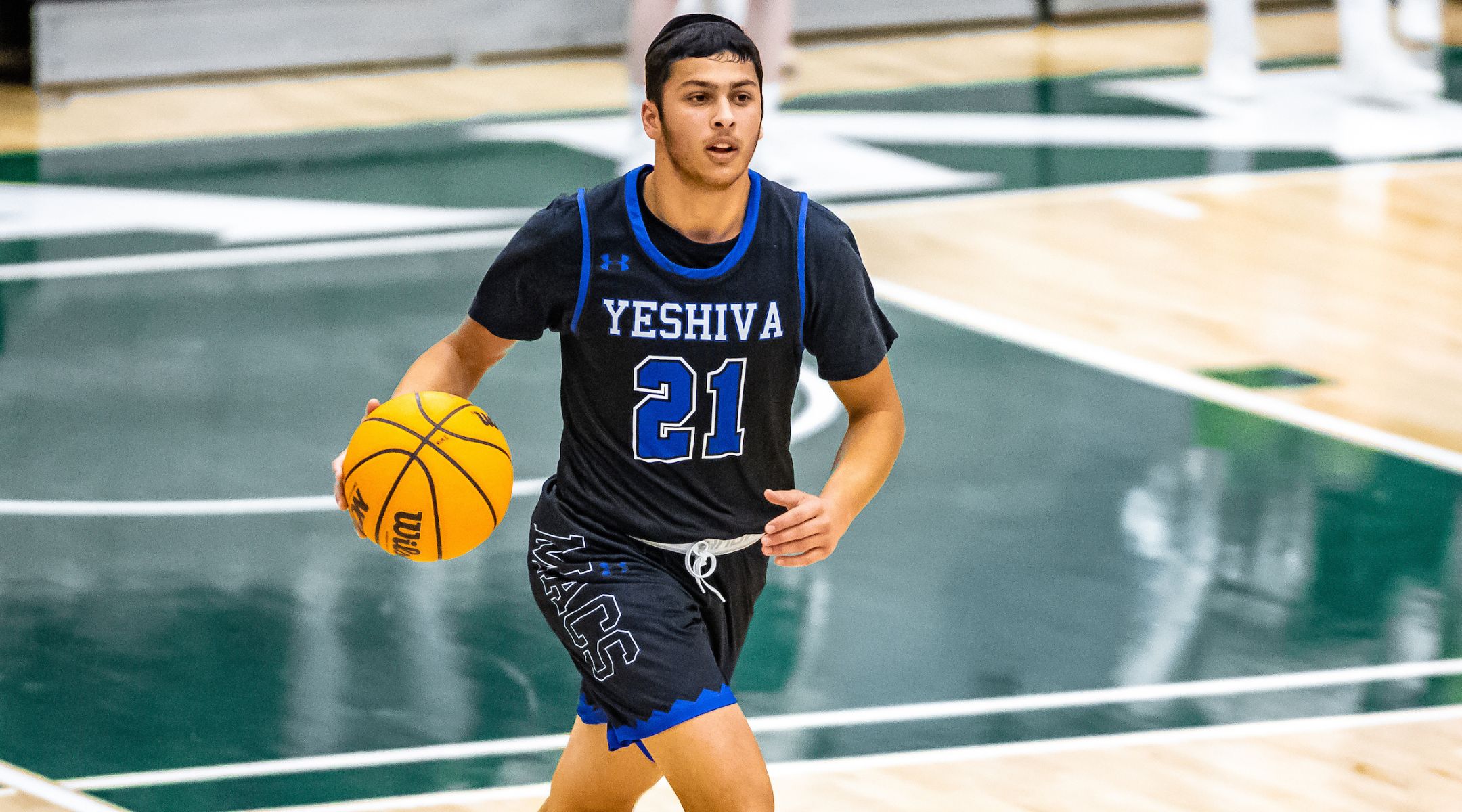 Zevi Samet is a star of the Yeshiva University Maccabees men’s basketball team. (Kodiak Creative/Jimmy Naprstek)