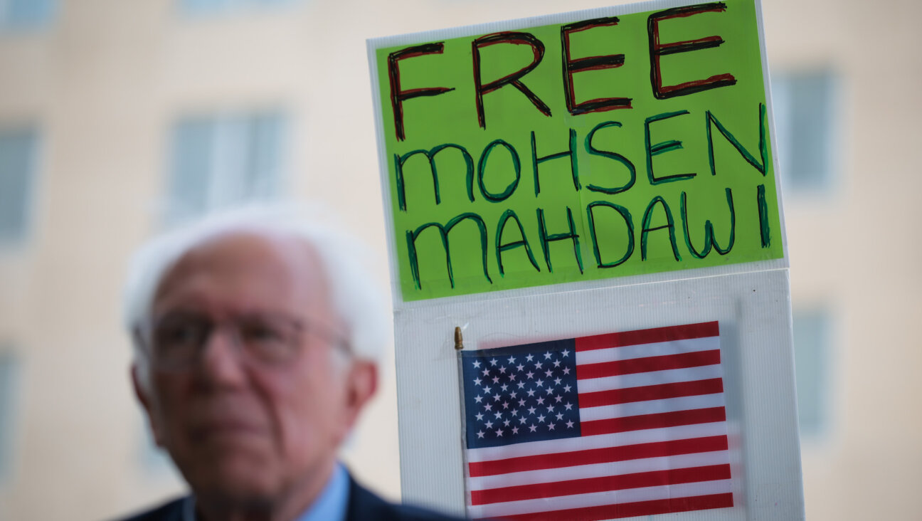 Supporters hold up signs behind U.S. Sen. Bernie Sanders of Vermont during a rally held by Congress members in support of detained Columbia student Mohsen Mahdawi on April 29, 2025 in Washington, DC. (Kayla Bartkowski/Getty Images)