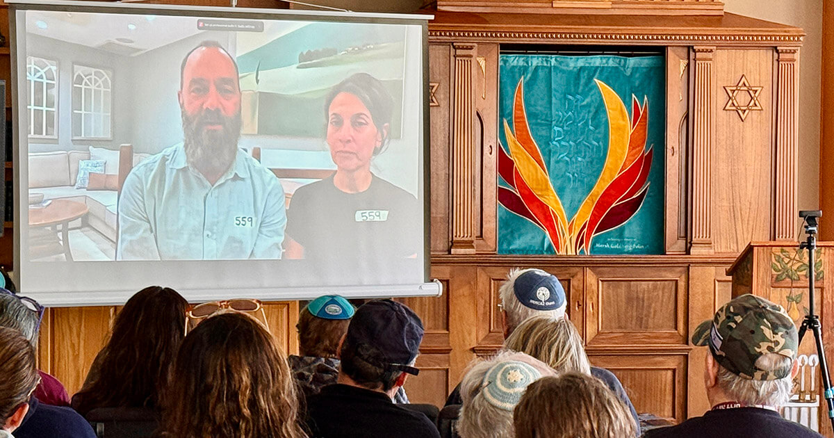 Jon Polin and Rachel Goldberg-Polin joined by video conference to a dedication of an ark curtain in memory of their son, Hersh, at Camp Ramah Darom.