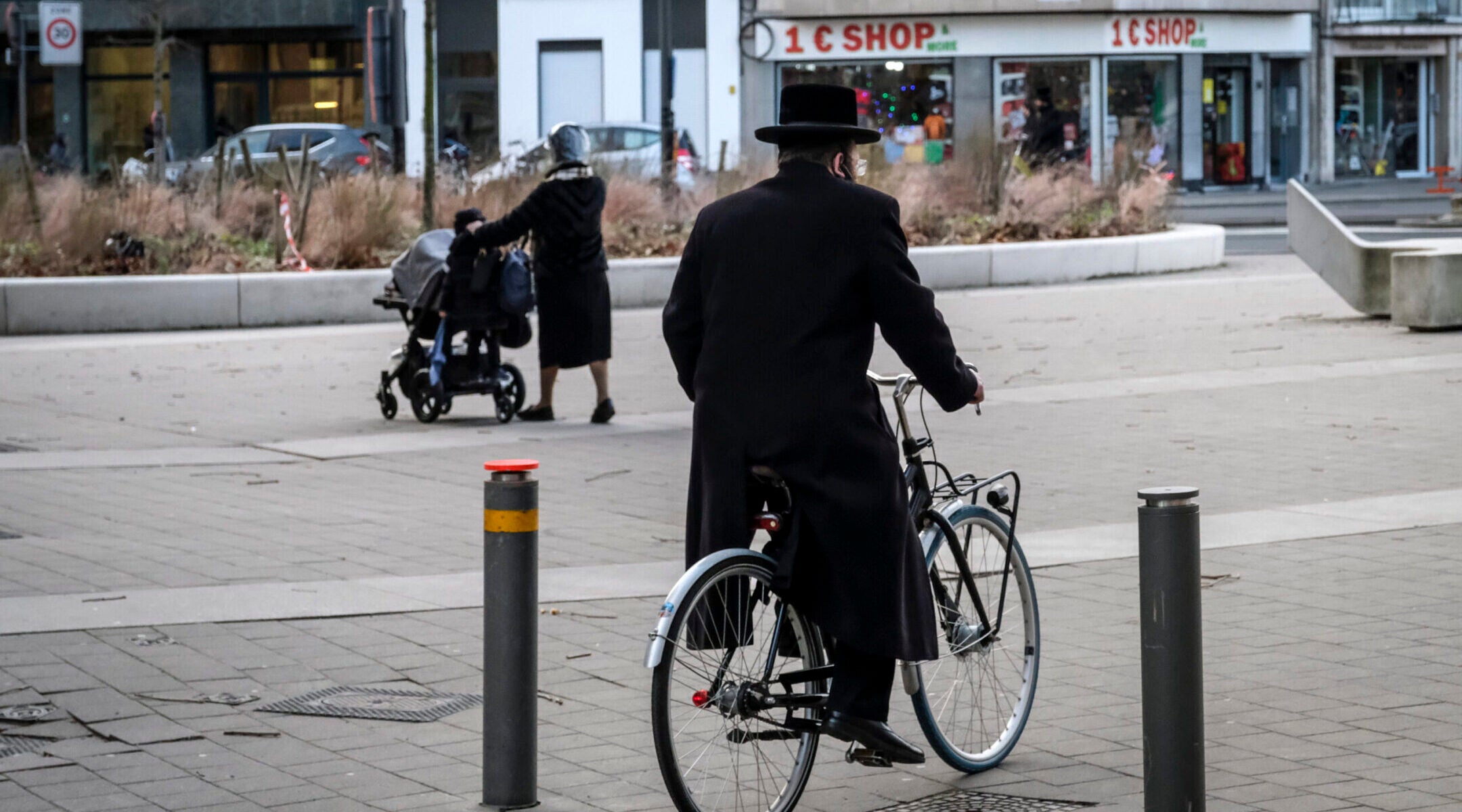 An Orthodox Jewish man bicycles in a neighborhood of Antwerp, Belgium, January 21, 2021. (Dirk Waem/Belga Mag/AFP via Getty Images)