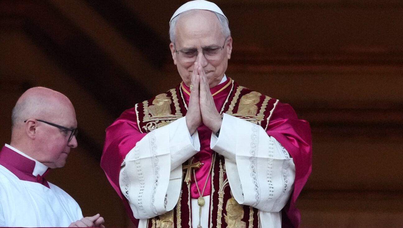 Pope Leo XIV, in his first official appearance, greeting the waiting crowd from the Vatican balcony.