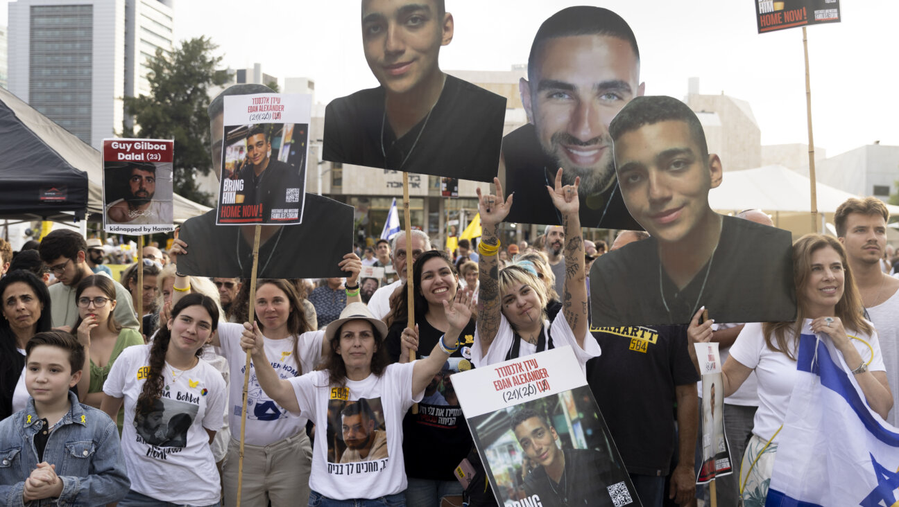 Supporters react as they watch a live stream of the release of hostage Edan Alexander in Tel Aviv.