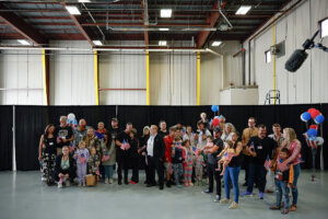 Newly arrived South Africans wait to hear welcome statements from U.S. government officials in a hangar near Washington Dulles International Airport on May 12.