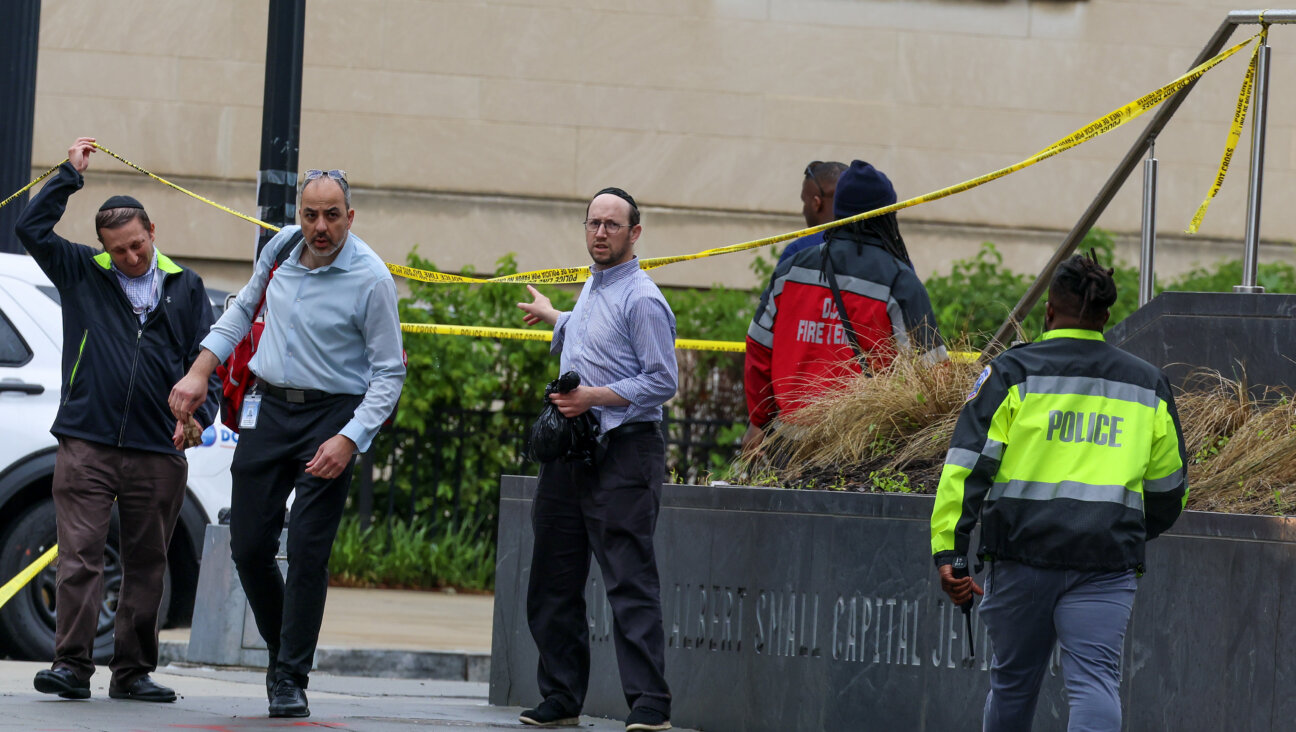 Police and investigators work at the crime scene where two Israeli embassy staff members were killed Wednesday evening outside an event at the Capital Jewish Museum.