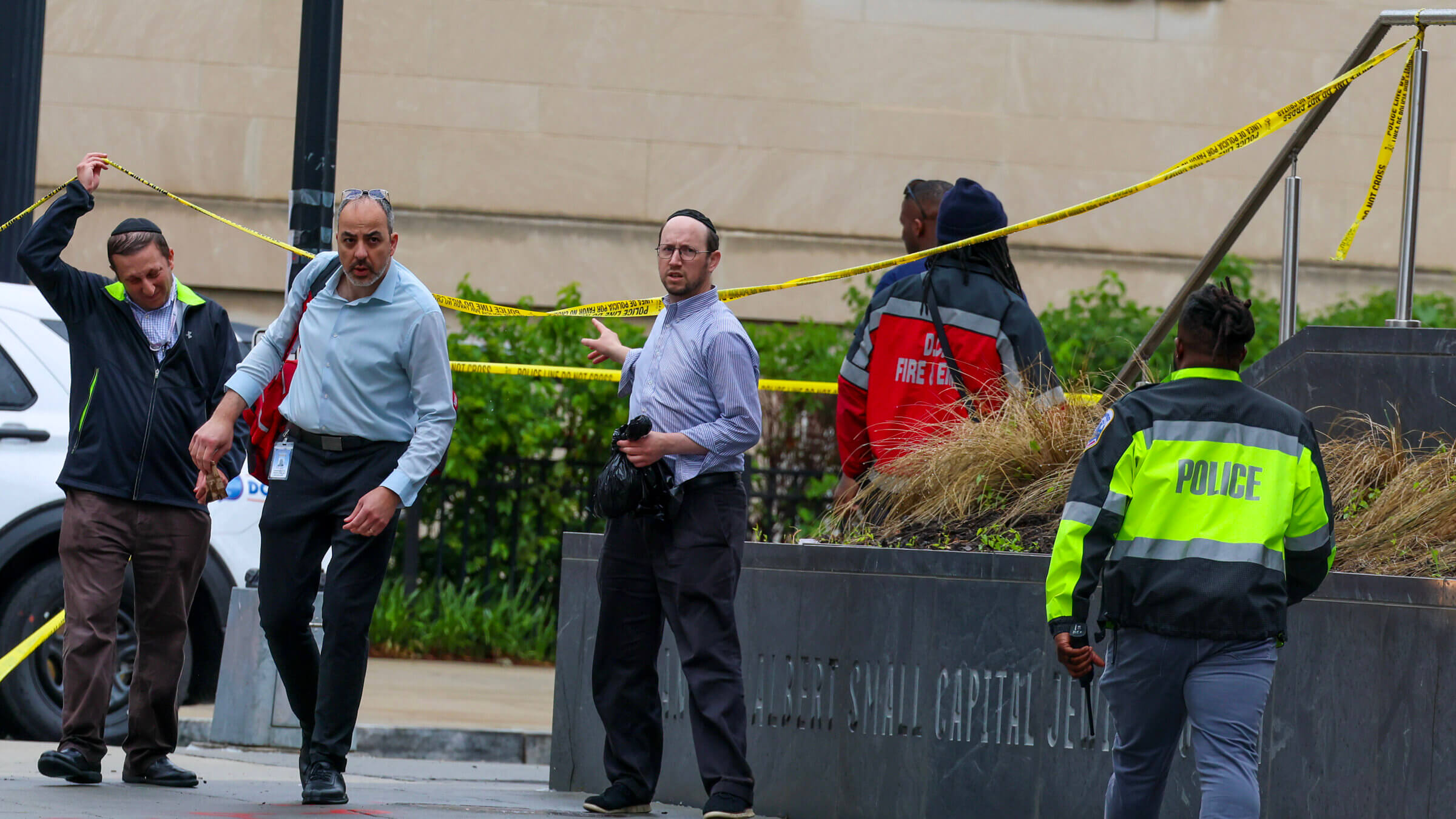 Police and investigators work at the crime scene where two Israeli embassy staff members were killed Wednesday evening outside an event at the Capital Jewish Museum.