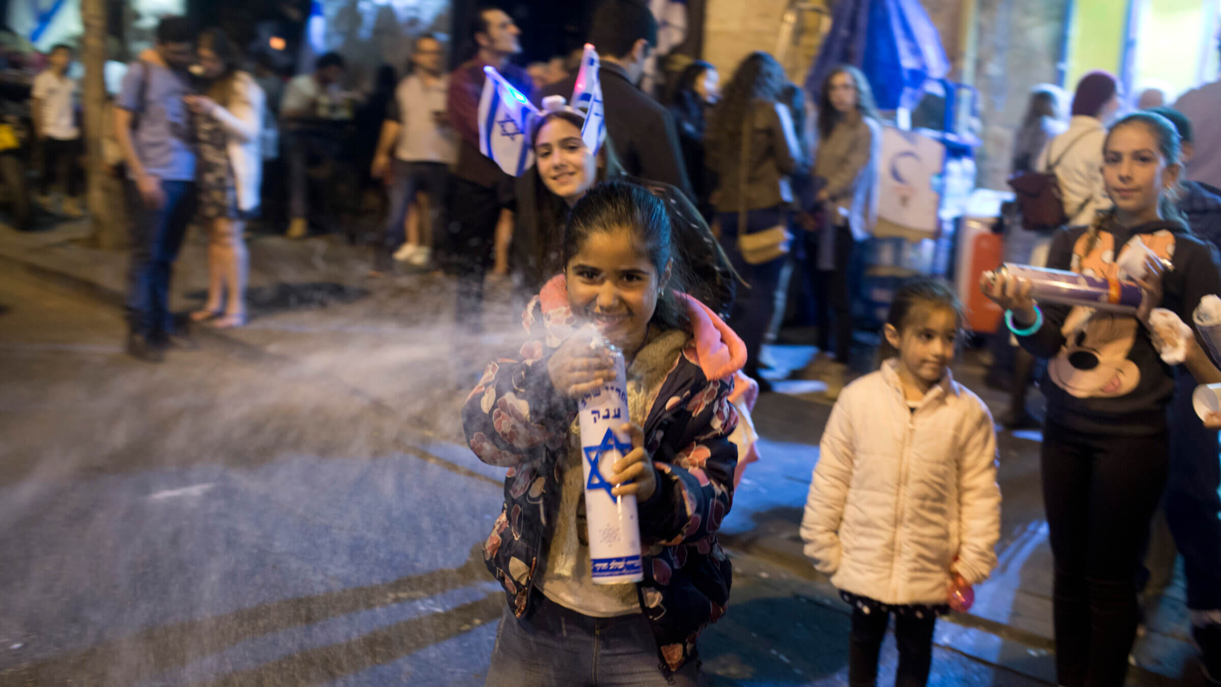 An Israeli girl sprays foam during 2017 Yom Ha'atzmaut celebrations in Jerusalem. Students from a Jewish school were attacked April 30 by Israeli teens in Tiberias after foam-spraying got out of hand.