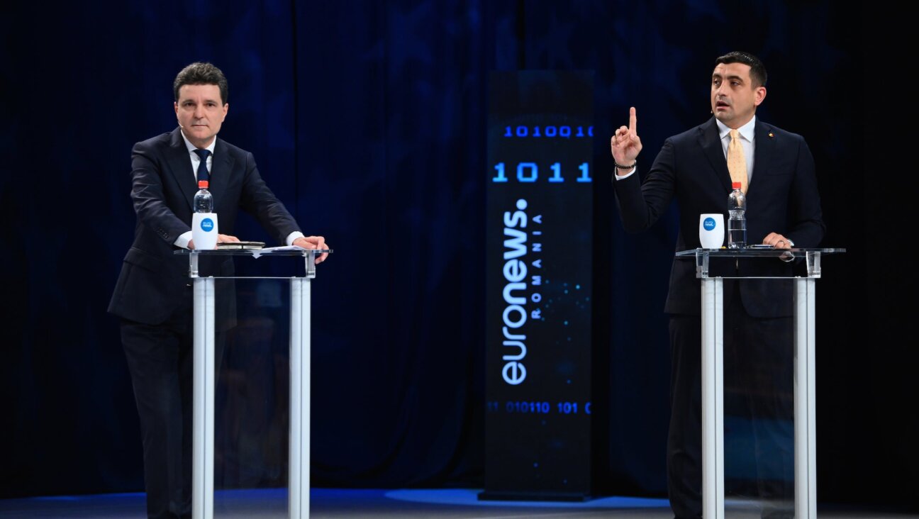 George Simion, left, during the live electoral debate with Pro-European independent presidential candidate and Bucharest Mayor Nicusor Dan in Bucharest, Romania, on May 8, 2025. (Alex Nicodim/NurPhoto via Getty Images)