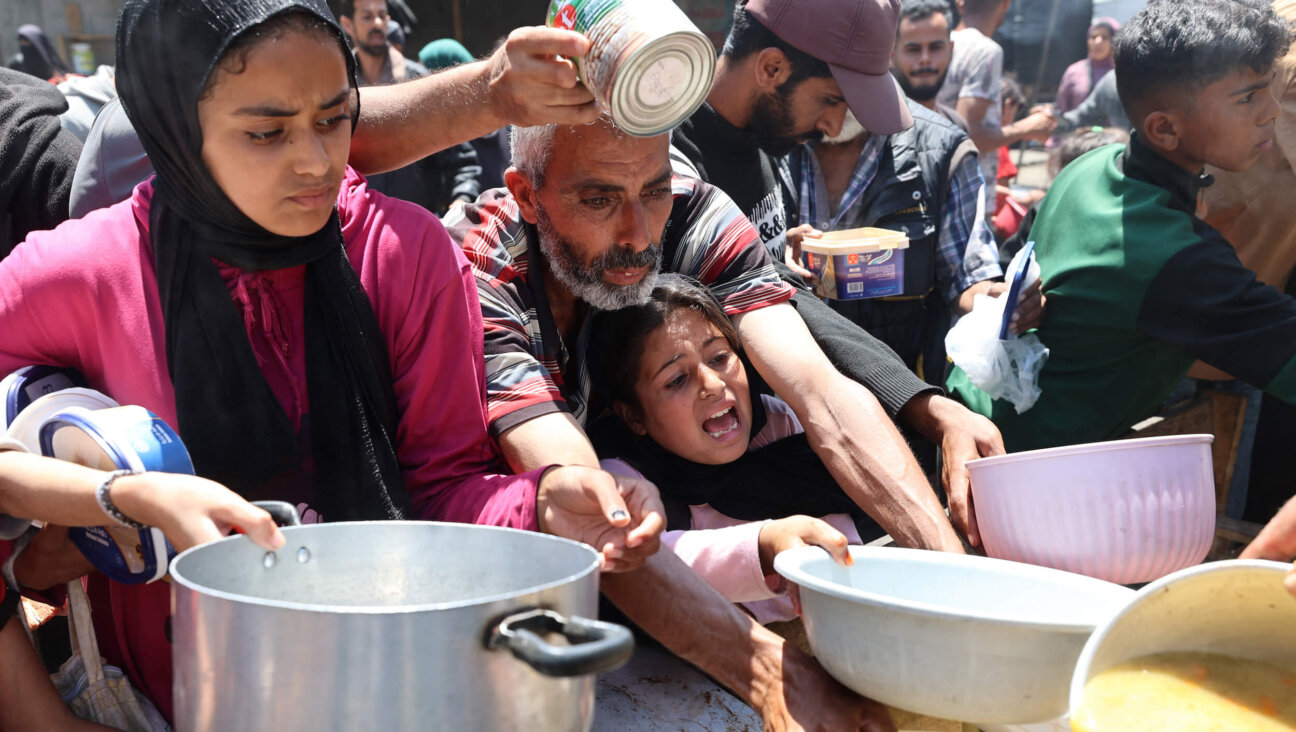 Palestinians wait for a meal at a charity kitchen at the Nuseirat refugee camp in the central Gaza Strip on May 4. 