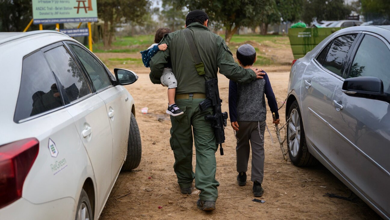 Israeli children visit their reservist father on Dec. 17, 2023 in Southern Israel. (Alexi J. Rosenfeld/Getty Images)