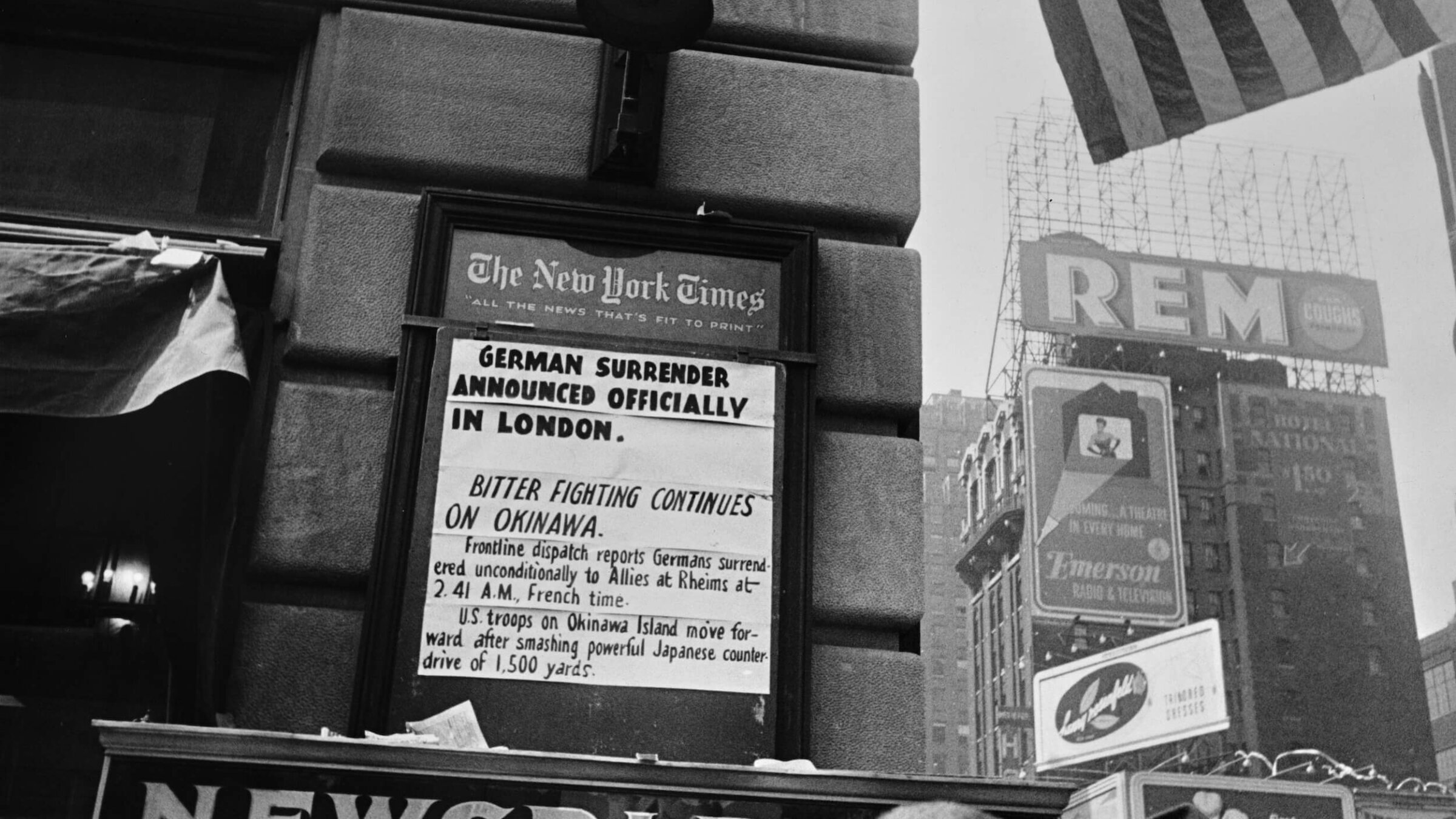 A New York Times newsboard announces Germany's surrender, marking the end of WWII in Europe, on May 8, 1945.