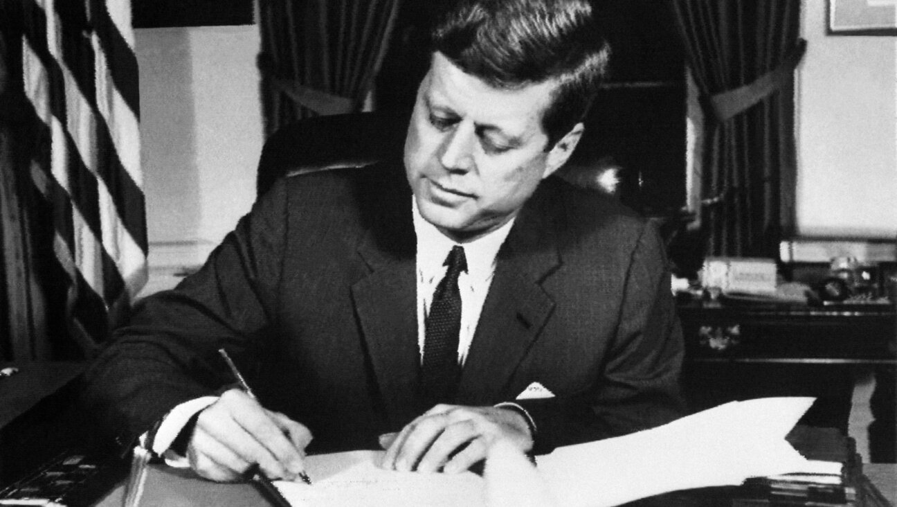 JFK signs the order of a naval blockade of Cuba, on Oct. 23, 1962.