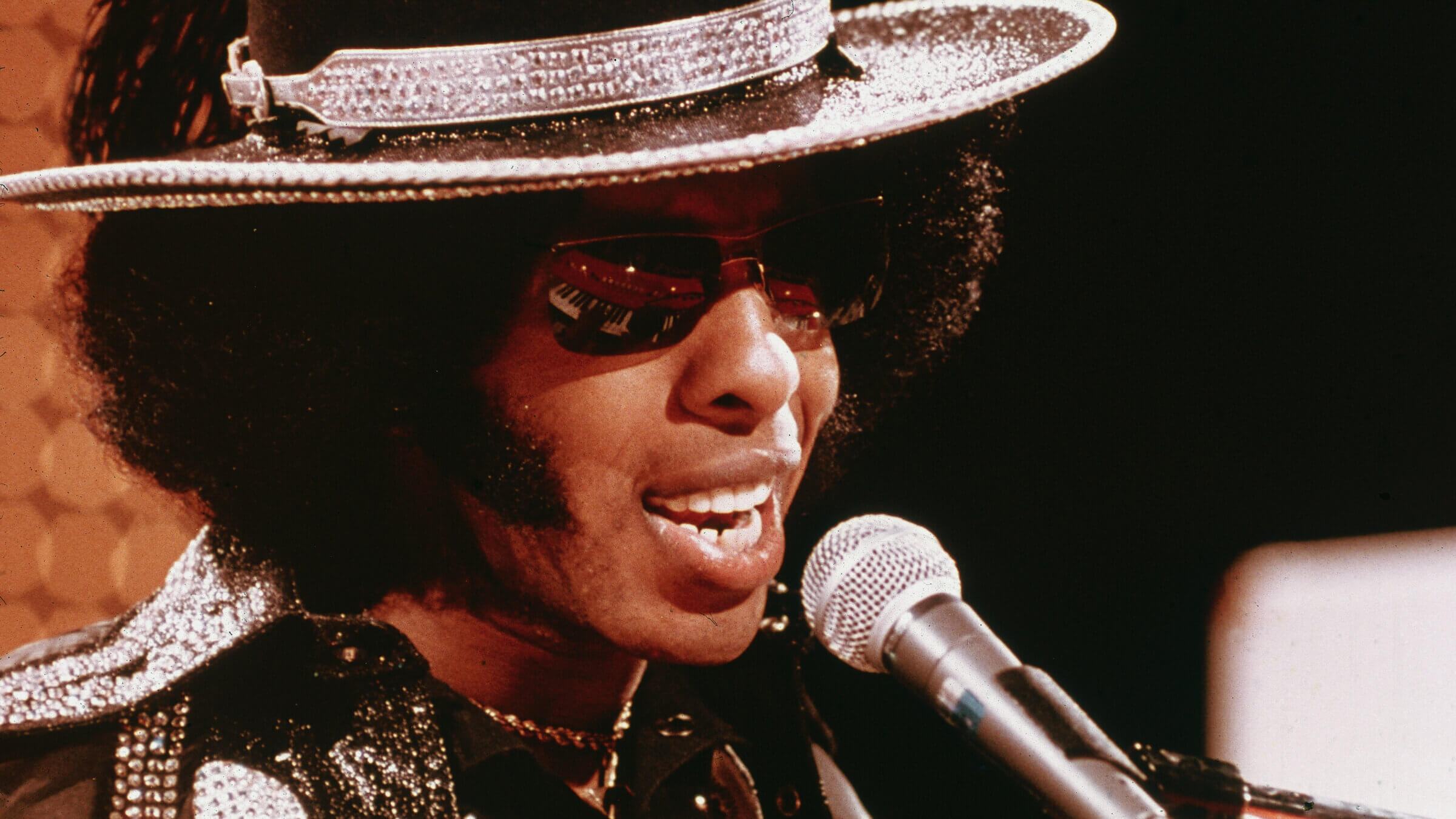 Sly Stone performing with his band Sly and the Family Stone on the television series  'Midnight Special, ' circa 1974. 