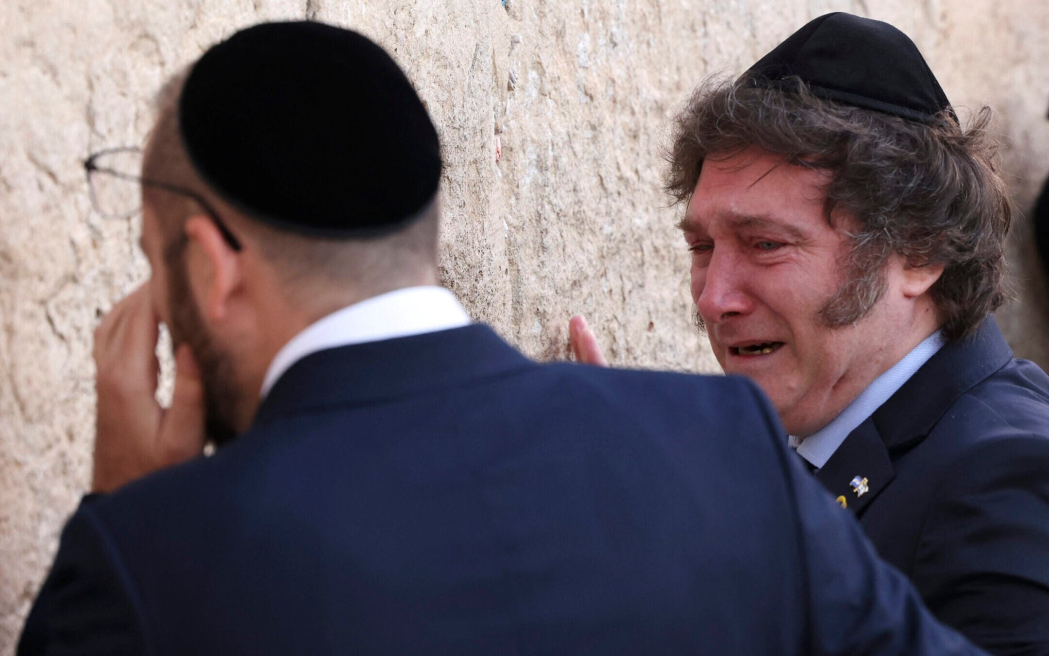 Argentina’s President Javier Milei (R) cries with Rabbi Shimon Axel Wahnish during a visit to the Western Wall in Jerusalem’s Old City on February 6, 2024. (Ronald Schemidt/AFP via Getty Images)