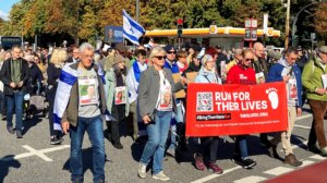 Hundreds of people demonstrate on the first anniversary of the Hamas attack on Israel with a banner reading “Run for their lives” for the release of hostages held by Hamas in Gaza in Hamburg, Germany, Oct. 6 2024. (Markus Klemm/picture alliance via Getty Images)