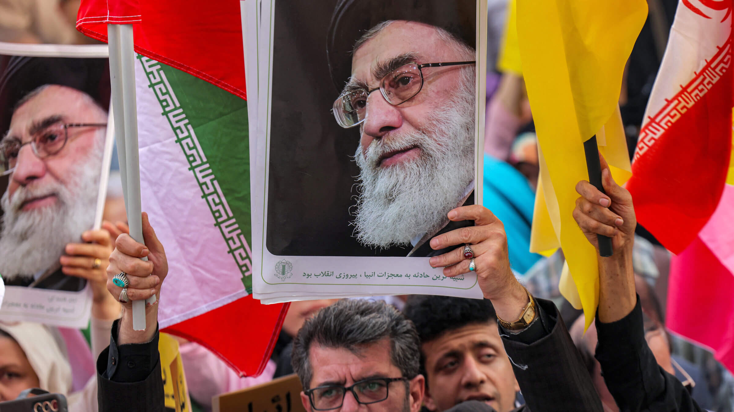 A demonstrator holds a picture of Iran's Supreme Leader Ayatollah Ali Khamenei in Tehran.