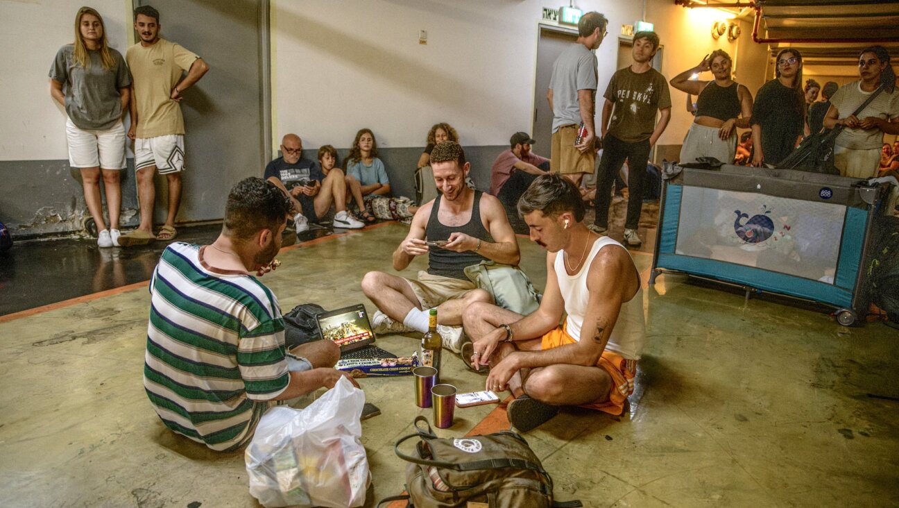 Israelis take shelter in a public underground facility during an Iranian ballistic missile barrage, June 14, 2025. 