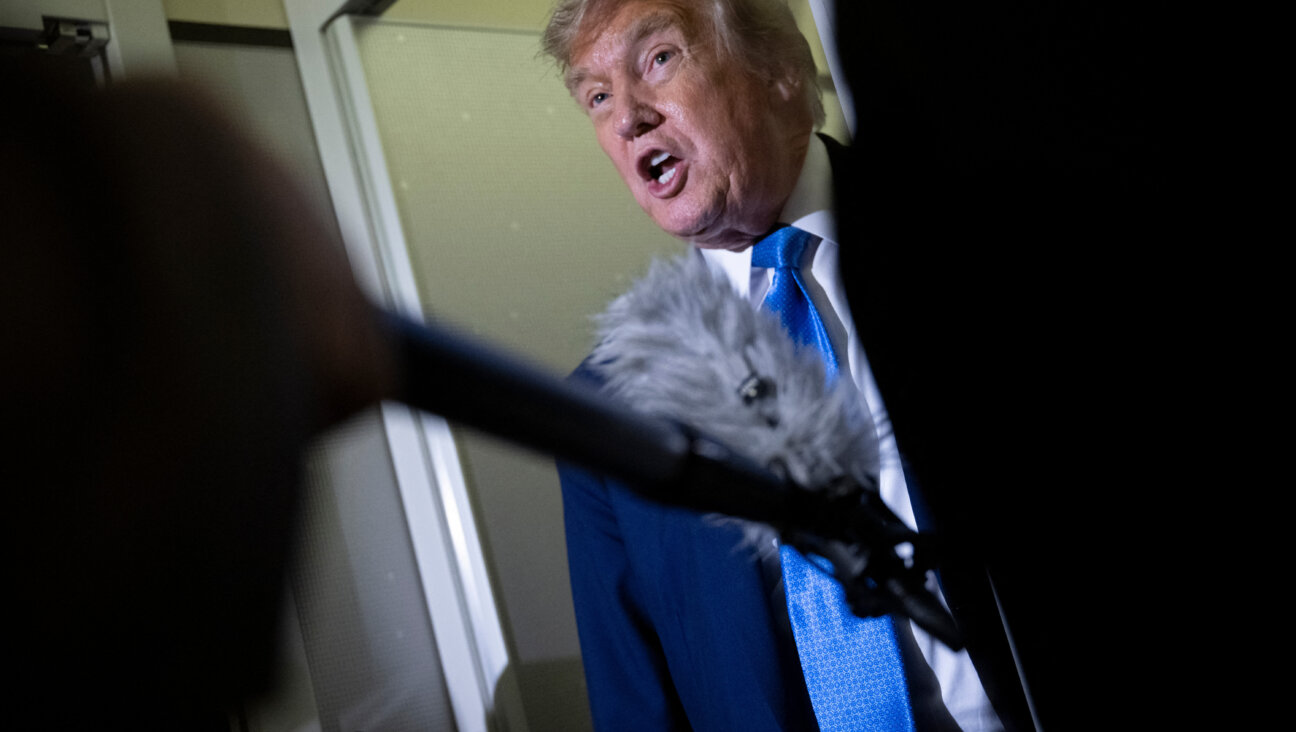 Donald Trump speaks to reporters about the G7 Summit on Air Force One.