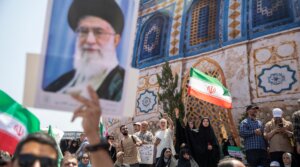 A demonstrator holds up a poster of Iran’s supreme leader, Ayatollah Ali Khamenei, during a protest against Israeli attacks on Iran, central Tehran, June 20, 2025.