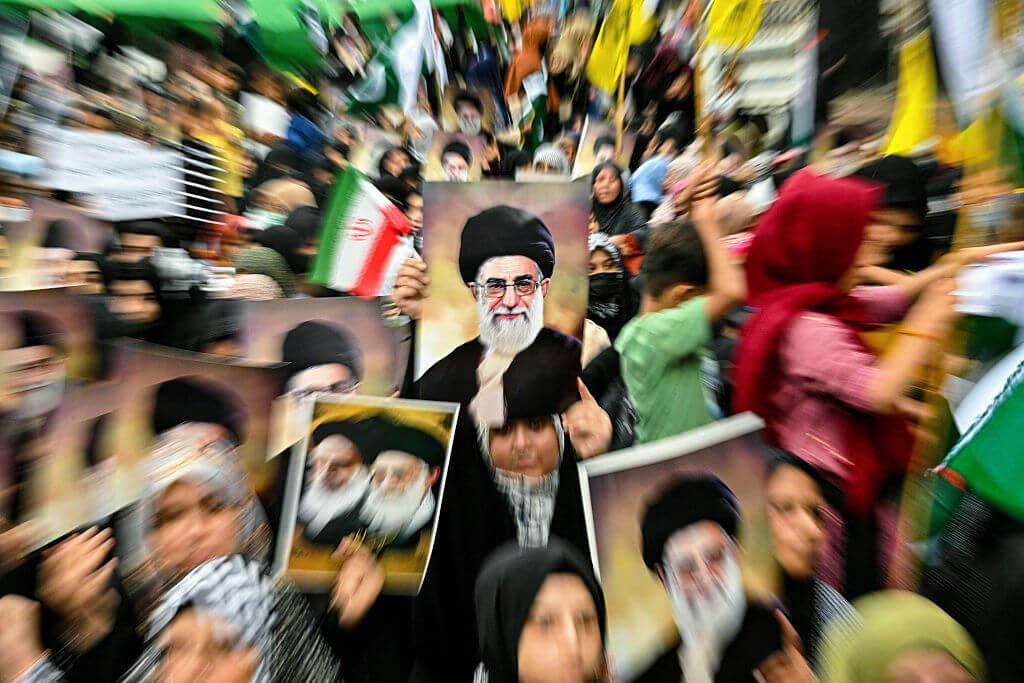 Shiite Muslims hold portraits of Iran's Ayatollah Ali Khamenei to condemn US and Israel's attacks on Iran, during a protest in Karachi on June 22. 
