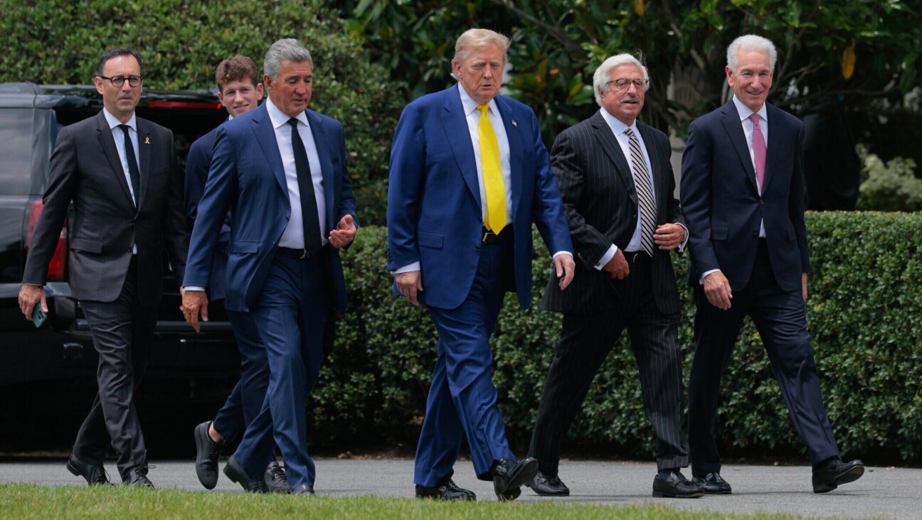 President Donald Trump is accompanied by newly appointed U.S. Ambassador to France Charles Kushner (R) and other guests as they head for a flag-raising ceremony for a newly installed flag pole on the South Lawn of the White House on June 18, 2025 in Washington, D.C. (Chip Somodevilla/Getty Images)