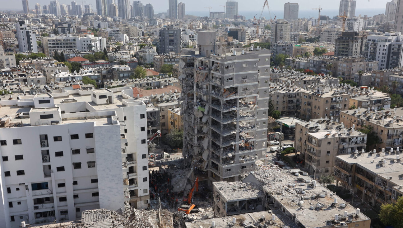 Israeli rescuers search through the rubble at the site of an overnight Iranian missile strike in Bat Yam, near Tel Aviv, on June 15.