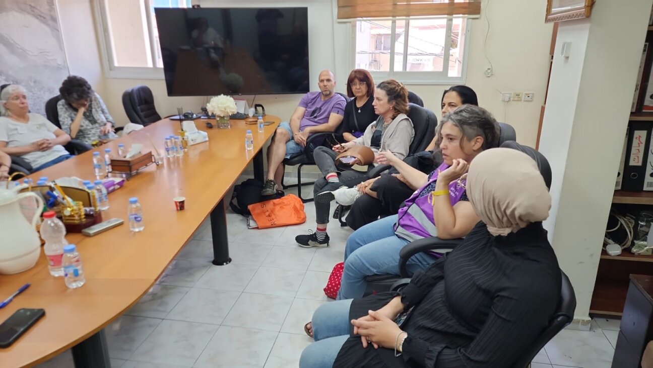 Tali Gillan meets with municipal workers in Tamra following a deadly missile strike there. (Courtesy Gillan)