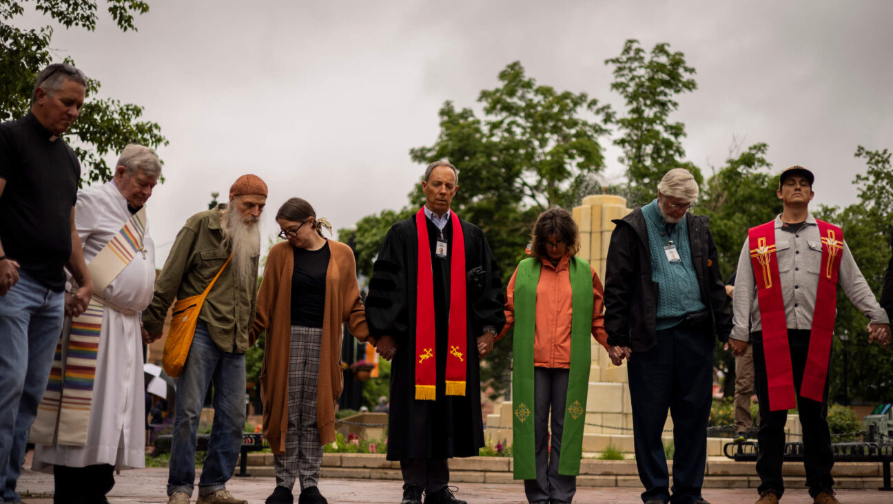Local faith leaders and members of the community conduct a prayer vigil for the victims of a fire attack outside the Boulder County Courthouse on June 3 in Boulder, Colorado. 
