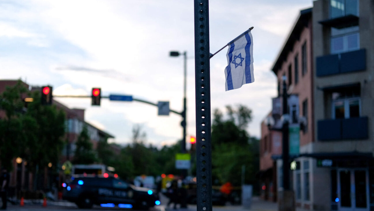 An Israeli flag is fixed to a street sign near Pearl Street in Boulder, Colorado, on the scene of a Sunday attack on demonstrators calling for the release of Israeli hostages held in Gaza.